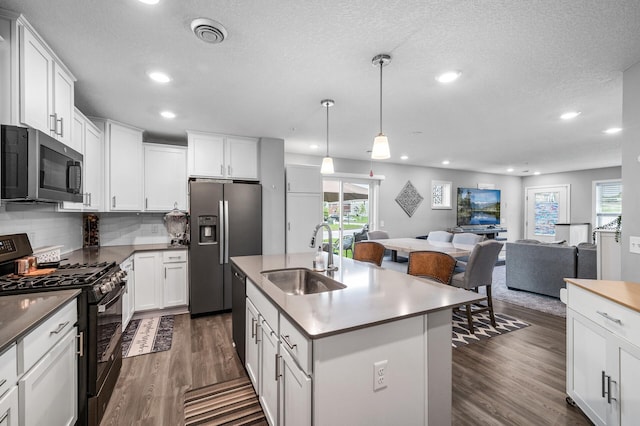 7243 Ada Dr, Lino Lakes, MN 55038 - kitchen with black appliances, a sink, open floor plan, recessed lighting, and dark wood finished floors