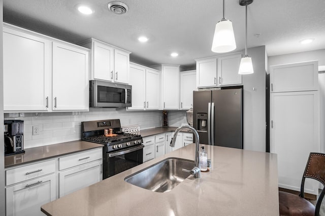 7243 Ada Dr, Lino Lakes, MN 55038 - kitchen featuring stainless steel appliances, a sink, backsplash, white cabinets, and recessed lighting