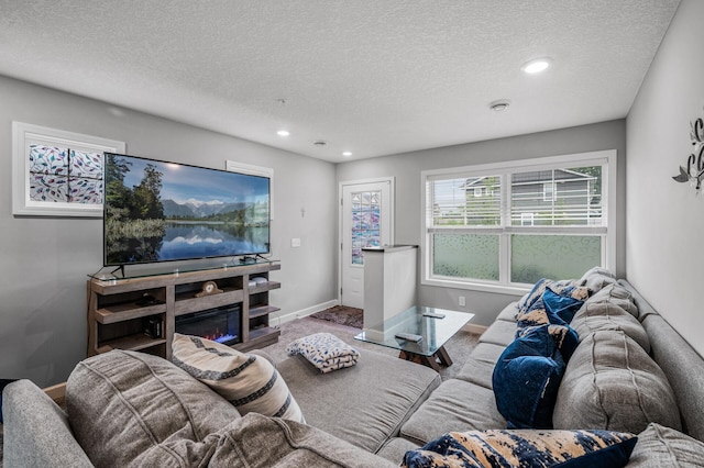 7243 Ada Dr, Lino Lakes, MN 55038 - carpeted living area featuring a textured ceiling, recessed lighting, and baseboards