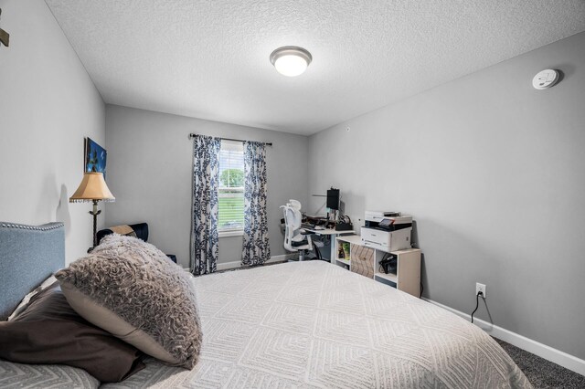 7243 Ada Dr, Lino Lakes, MN 55038 - bedroom with a textured ceiling, baseboards, and carpet