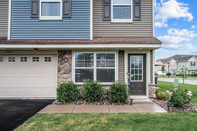 7243 Ada Dr, Lino Lakes, MN 55038 - entrance to property featuring stone siding and an attached garage