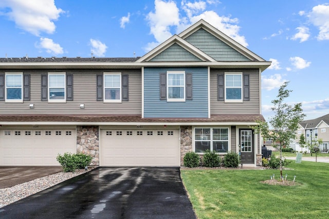 7243 Ada Dr, Lino Lakes, MN 55038 - multi unit property featuring driveway, a front yard, stone siding, and a garage
