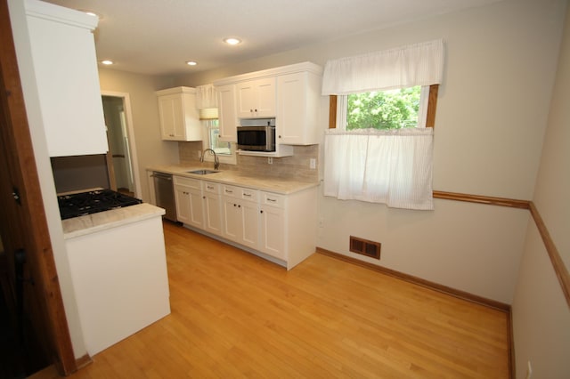 3249 Zane Ave N, Crystal, MN 55422 - kitchen with a sink, appliances with stainless steel finishes, white cabinets, light countertops, and recessed lighting
