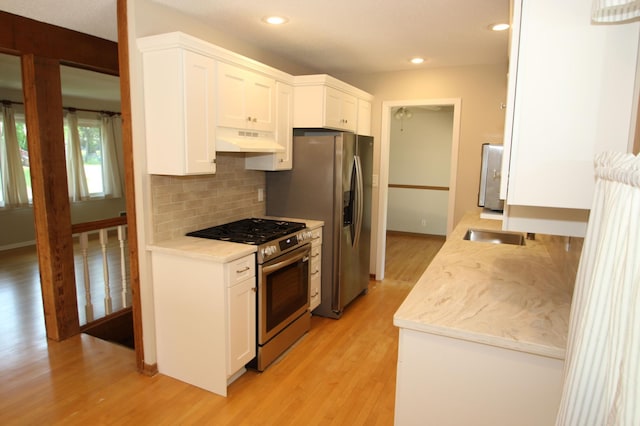 3249 Zane Ave N, Crystal, MN 55422 - kitchen featuring stainless steel appliances, under cabinet range hood, light wood-style flooring, backsplash, and recessed lighting