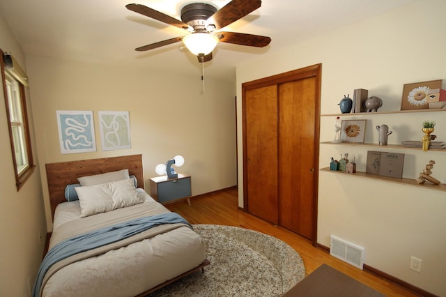 3249 Zane Ave N, Crystal, MN 55422 - bedroom featuring wood finished floors, a closet, a ceiling fan, and baseboards