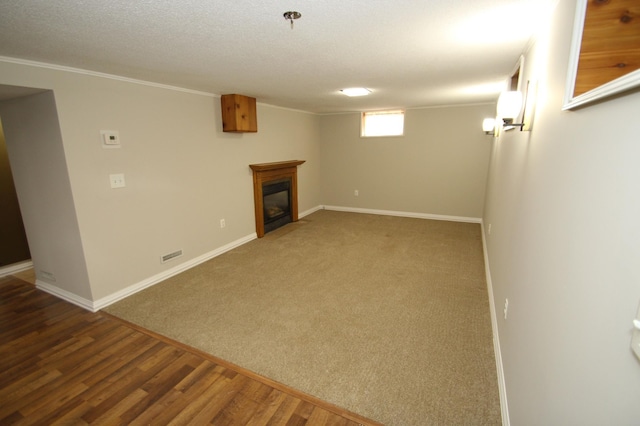 3249 Zane Ave N, Crystal, MN 55422 - basement with baseboards, a glass covered fireplace, ornamental molding, wood finished floors, and carpet floors