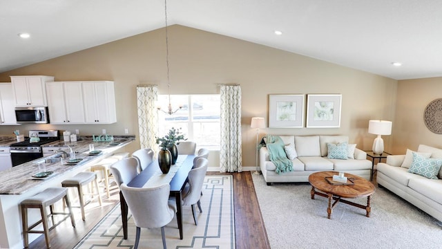 5200 Mustang Dr S, Woodbury, MN 55129 - living room with vaulted ceiling, light wood-style flooring, recessed lighting, and baseboards