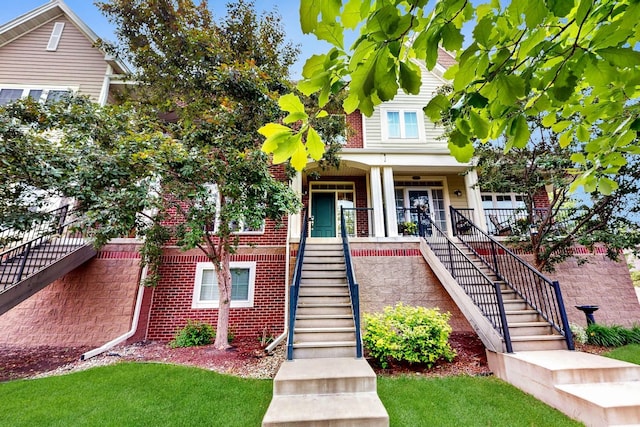 8102 Oakview Ln N Unit 39, Maple Grove, MN 55369 - view of front of house with stairway, a porch, and brick siding