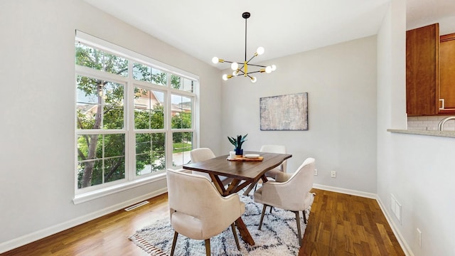 8102 Oakview Ln N Unit 39, Maple Grove, MN 55369 - dining area featuring a chandelier, baseboards, and wood finished floors