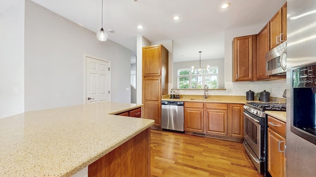 8102 Oakview Ln N Unit 39, Maple Grove, MN 55369 - kitchen featuring stainless steel appliances, a sink, light wood-type flooring, brown cabinetry, and recessed lighting