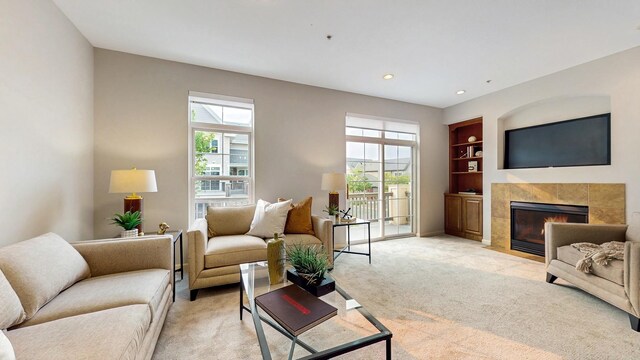8102 Oakview Ln N Unit 39, Maple Grove, MN 55369 - living area with plenty of natural light, built in features, a tiled fireplace, light carpet, and recessed lighting