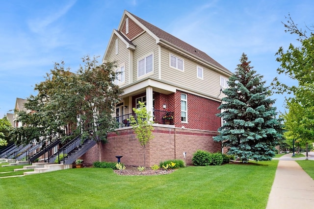 8102 Oakview Ln N Unit 39, Maple Grove, MN 55369 - view of side of home with a yard, a porch, brick siding, and stairs