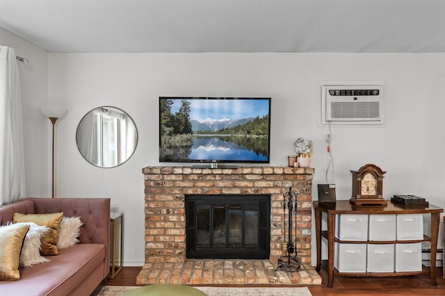 2220 Ridge Dr Unit 16, Saint Louis Park, MN 55416 - living area with wood finished floors, an AC wall unit, a fireplace, and a baseboard heating unit
