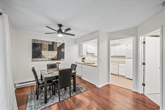 2220 Ridge Dr Unit 16, Saint Louis Park, MN 55416 - dining area with a baseboard radiator, ceiling fan, and wood finished floors
