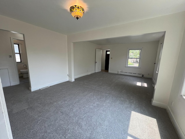 2619 2nd Ave W, Hibbing, MN 55746 - empty room featuring a baseboard radiator, dark carpet, and baseboards