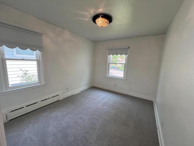 2619 2nd Ave W, Hibbing, MN 55746 - carpeted empty room with a baseboard heating unit and baseboards