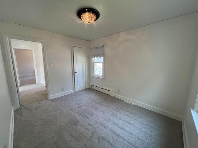 2619 2nd Ave W, Hibbing, MN 55746 - spare room with a baseboard heating unit, carpet floors, and baseboards