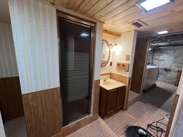 2619 2nd Ave W, Hibbing, MN 55746 - bathroom with vanity, wood walls, wallpapered walls, wainscoting, and washer / dryer