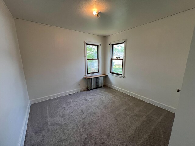 2619 2nd Ave W, Hibbing, MN 55746 - empty room featuring radiator and carpet floors