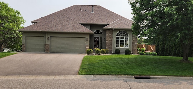 11855 37th St NE, Saint Michael, MN 55376 - view of front facade with asphalt driveway, an attached garage, a front yard, and a shingled roof