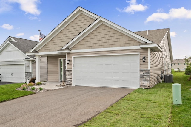 17266 204th Ave NW, Big Lake, MN 55309 - craftsman inspired home featuring stone siding, central AC unit, a front yard, driveway, and a garage