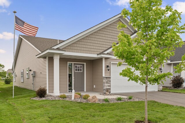 17266 204th Ave NW, Big Lake, MN 55309 - view of front of property with a front yard, asphalt driveway, a garage, and roof with shingles