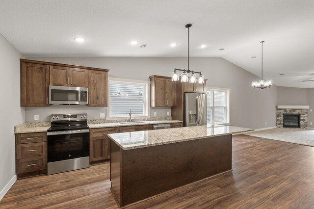 17266 204th Ave NW, Big Lake, MN 55309 - kitchen with appliances with stainless steel finishes, vaulted ceiling, a sink, open floor plan, and plenty of natural light