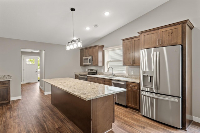 17266 204th Ave NW, Big Lake, MN 55309 - kitchen featuring appliances with stainless steel finishes, a sink, lofted ceiling, a kitchen island, and dark wood-style flooring