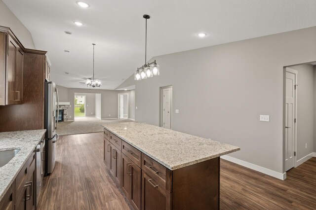 17266 204th Ave NW, Big Lake, MN 55309 - kitchen featuring open floor plan, appliances with stainless steel finishes, dark brown cabinetry, baseboards, and lofted ceiling
