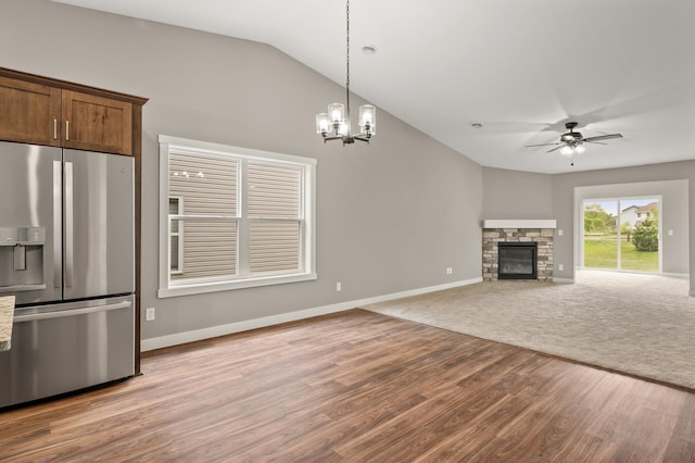 17266 204th Ave NW, Big Lake, MN 55309 - unfurnished living room with wood finished floors, a ceiling fan, lofted ceiling, baseboards, and a fireplace