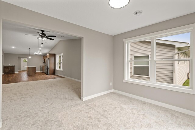 17266 204th Ave NW, Big Lake, MN 55309 - spare room with carpet floors, lofted ceiling, baseboards, and a ceiling fan
