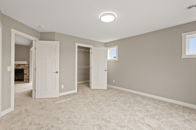 17266 204th Ave NW, Big Lake, MN 55309 - unfurnished bedroom featuring carpet, a fireplace, baseboards, a spacious closet, and a closet