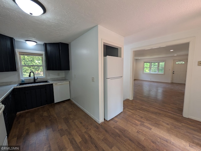 353 44th Ave NW, Powers Twp, MN 56435 - kitchen featuring white appliances, a sink, dark cabinetry, a textured ceiling, and dark wood-type flooring