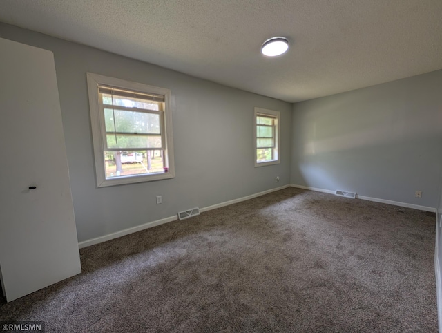 353 44th Ave NW, Powers Twp, MN 56435 - unfurnished room with carpet flooring, a textured ceiling, and baseboards