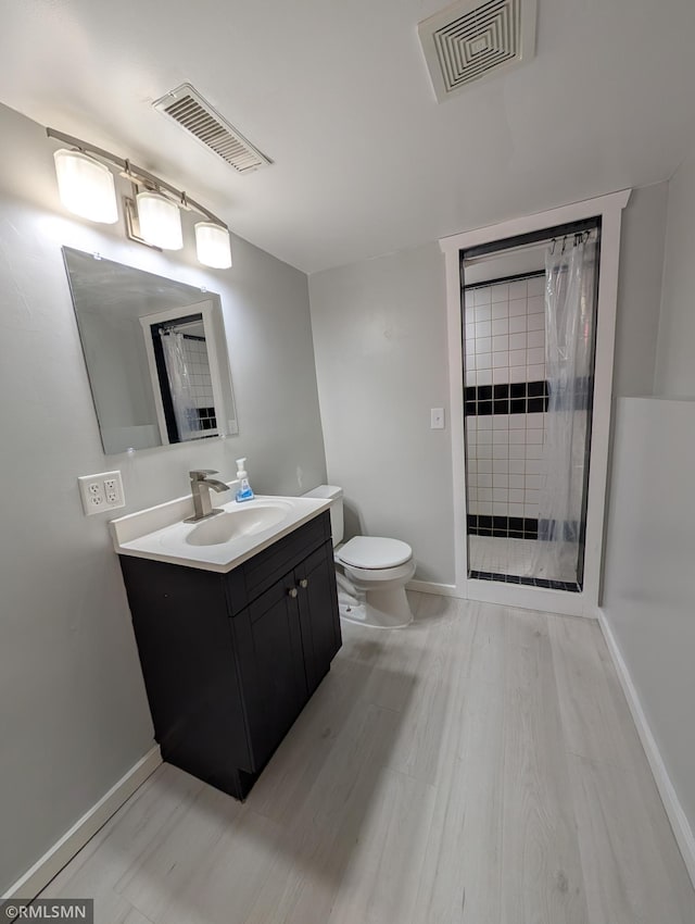 353 44th Ave NW, Powers Twp, MN 56435 - bathroom featuring vanity, toilet, a stall shower, and baseboards