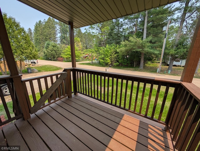 353 44th Ave NW, Powers Twp, MN 56435 - wooden deck with a lawn and view of scattered trees