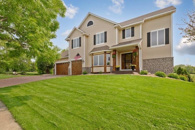 1900 Legacy Dr, Faribault, MN 55021 - view of front of home featuring driveway, a front lawn, brick siding, and an attached garage