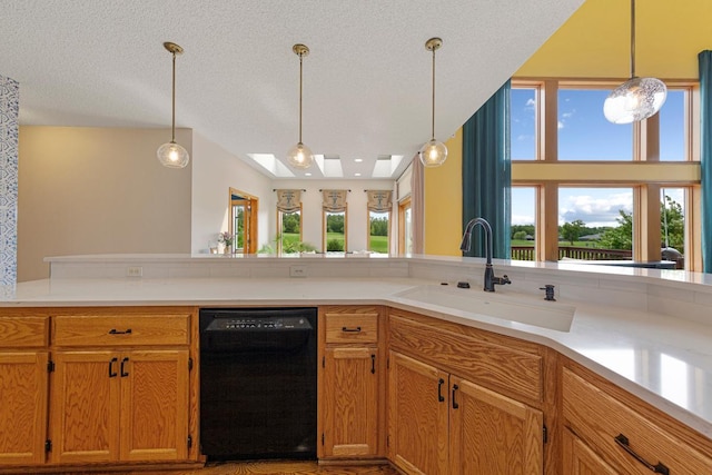 1900 Legacy Dr, Faribault, MN 55021 - kitchen with dishwasher, a sink, decorative light fixtures, light countertops, and a textured ceiling