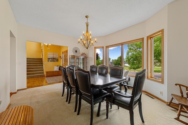 1900 Legacy Dr, Faribault, MN 55021 - dining room featuring light colored carpet, a chandelier, stairs, baseboards, and a textured ceiling