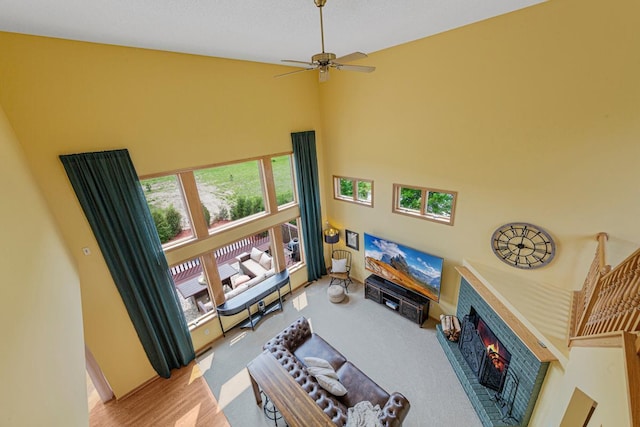 1900 Legacy Dr, Faribault, MN 55021 - living room with a fireplace, a towering ceiling, and a ceiling fan