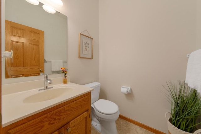 1900 Legacy Dr, Faribault, MN 55021 - bathroom with vanity, toilet, tile patterned flooring, and baseboards