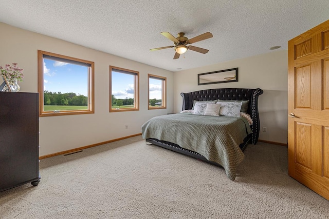 1900 Legacy Dr, Faribault, MN 55021 - bedroom featuring light colored carpet, baseboards, a textured ceiling, and ceiling fan