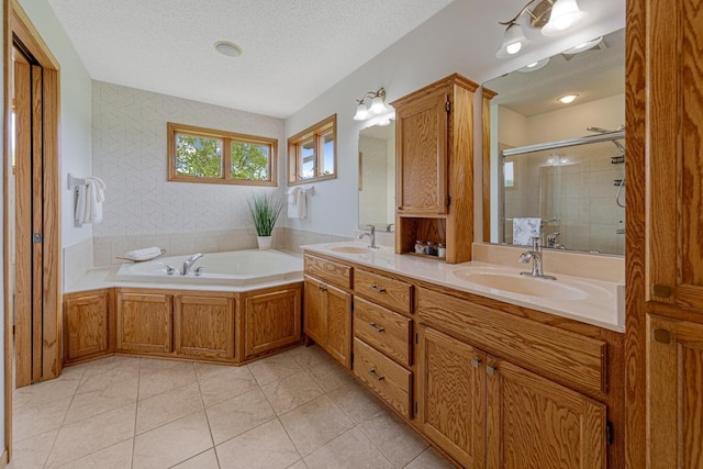 1900 Legacy Dr, Faribault, MN 55021 - bathroom featuring double vanity, a garden tub, a textured ceiling, a stall shower, and tile patterned floors