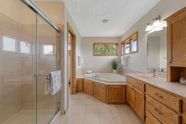 1900 Legacy Dr, Faribault, MN 55021 - full bathroom featuring a stall shower, vanity, a garden tub, tile patterned flooring, and a textured ceiling
