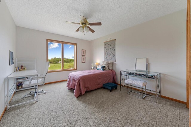 1900 Legacy Dr, Faribault, MN 55021 - bedroom with carpet, a textured ceiling, baseboards, and ceiling fan