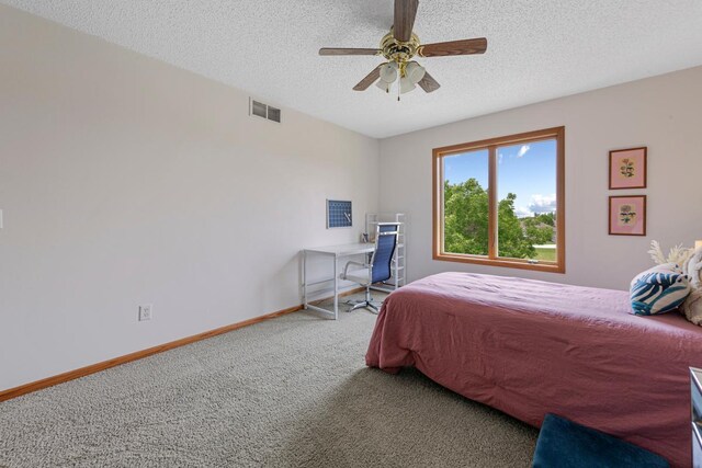 1900 Legacy Dr, Faribault, MN 55021 - carpeted bedroom featuring a textured ceiling, baseboards, and a ceiling fan