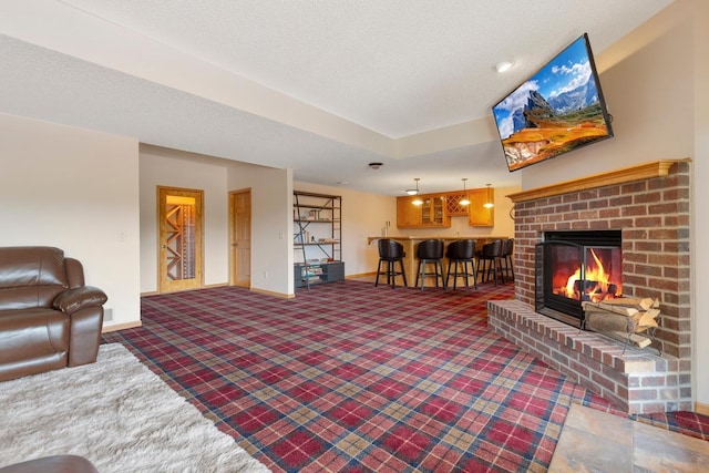 1900 Legacy Dr, Faribault, MN 55021 - carpeted living room with baseboards, a fireplace, and bar area