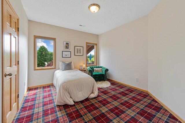 1900 Legacy Dr, Faribault, MN 55021 - bedroom with a textured ceiling and baseboards