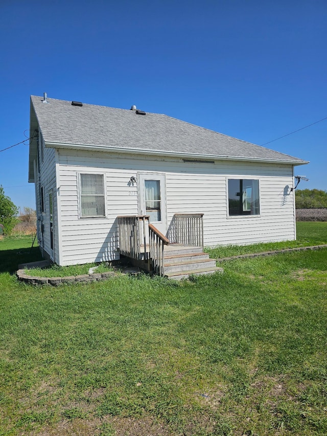 213 Harrison Ave N, Mentor, MN 56736 - rear view of house with a yard and roof with shingles