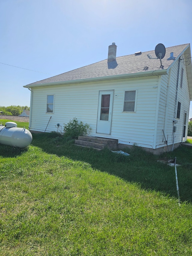 213 Harrison Ave N, Mentor, MN 56736 - rear view of house with a yard and a chimney